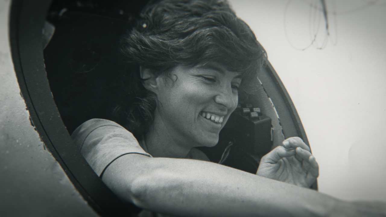 black and white photo of a woman smiling